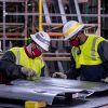 Mazda Toyota Manufacturing employees work on a body panel