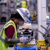 Mazda Toyota Manufacturing employee works on an engine