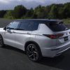 The 2023 Outlander PHEV driving on the street