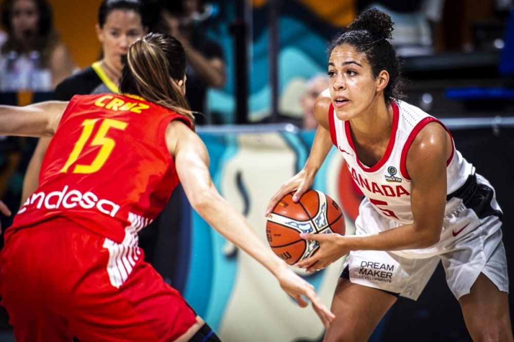 WNBA player Kia Nurse holding a basketball while playing for Team Canada during the Olympics