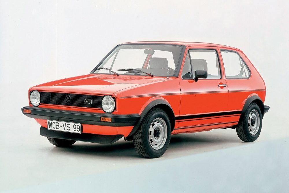 Front angles view of a coral 1975 Volkswagen Golf in front of a white background