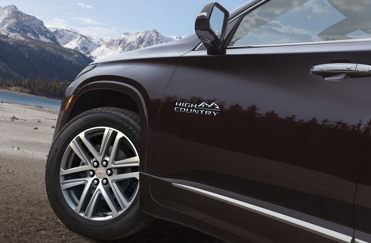 Close up view of 2022 Chevrolet Traverse High Country front wheel, mirror, and driver's side door