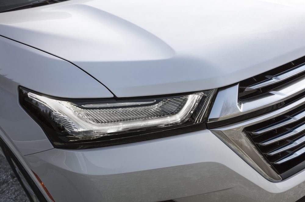 Close-up view of 2022 Chevrolet Traverse Premier headlamp and grille