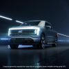 2022 Ford F-150 Lightning hero hot with headlights illuminated