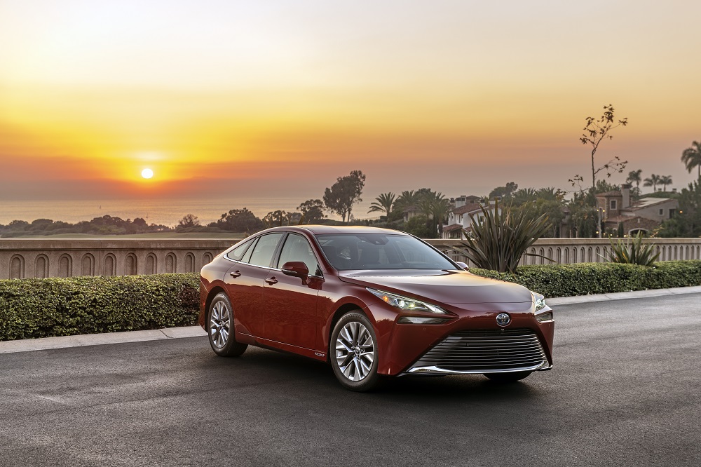 2022 Toyota Mirai XLE in Supersonic Red (parked, sunset)