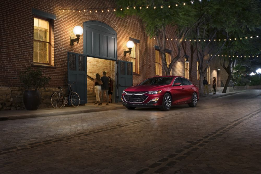 Red 2022 Chevrolet Malibu parked on a street at night