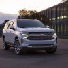 Front view of white 2021 Chevrolet Suburban with lights on