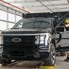 2022 Ford F-150 Lightning pre-production a UAW-represented worker inspects the inner door of a truck at Rouge Electric Vehicle Center