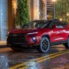 front and side view of red 2023 Chevrolet Blazer RS parked on city street at night