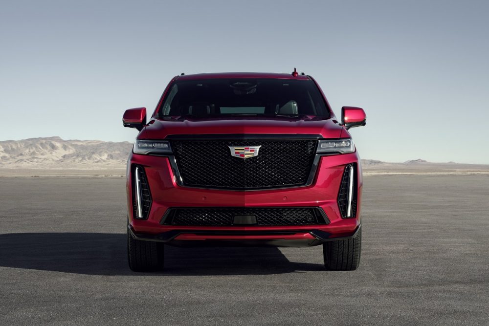 Front view of a red 2023 Cadillac Escalade-V in front of mountains