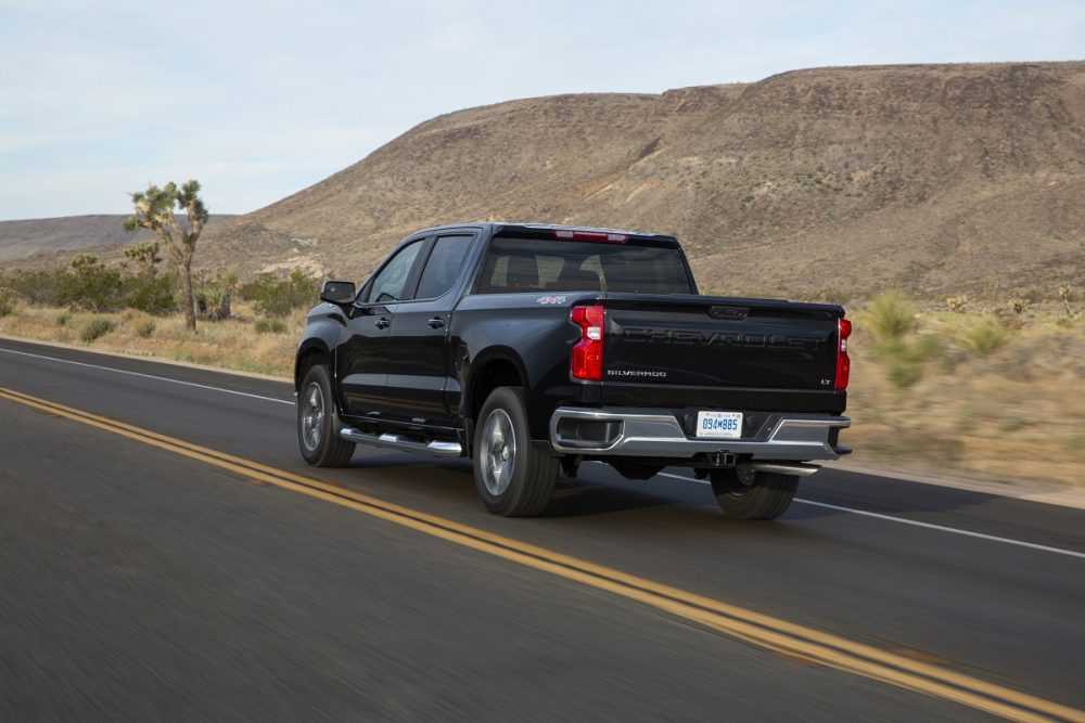 Rear side view of 2022 Chevrolet Silverado LT driving down road