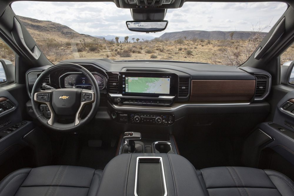 Wide view of 2022 Chevrolet Silverado High Country steering wheel, dashboard, console, and windshield