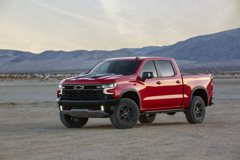 Front side view of red 2022 Chevrolet Silverado ZR2 with mountains in background