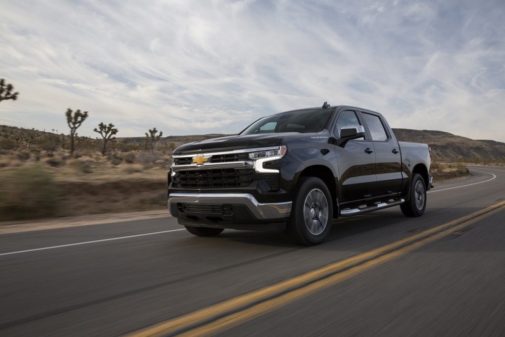 Front side view of black 2022 Chevrolet Silverado LT driving down road
