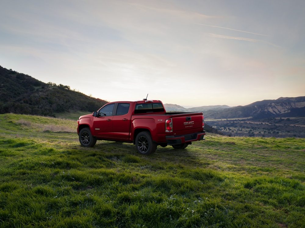 Rear side view of 2022 GMC Canyon Elevation in grassy meadow