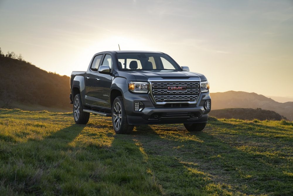 Front side view of 2022 GMC Canyon Denali backlit by sunset