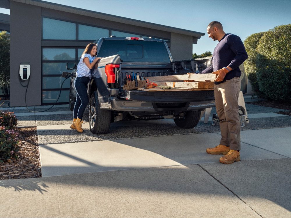 2022 Ford F-150 Lightning loading lumber into bed