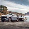 Ford F-150 Lightning backing a boat into the water