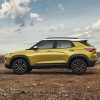 Profile view of yellow 2023 Chevrolet Trailblazer ACTIV parked with desert in background