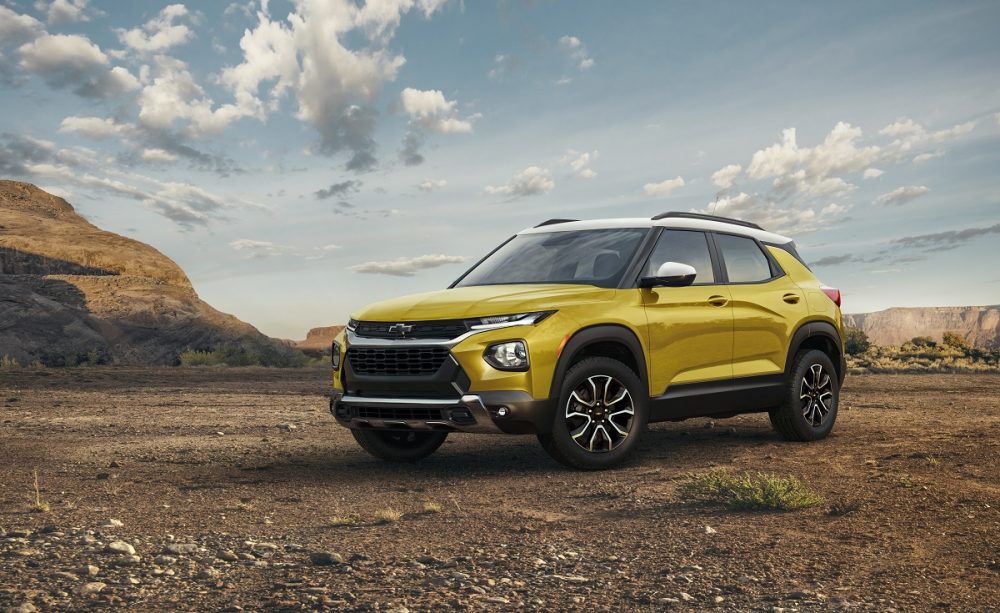 Front side view of yellow 2023 Chevrolet Trailblazer ACTIV parked with desert in background