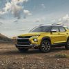 Front side view of yellow 2023 Chevrolet Trailblazer ACTIV parked with desert in background