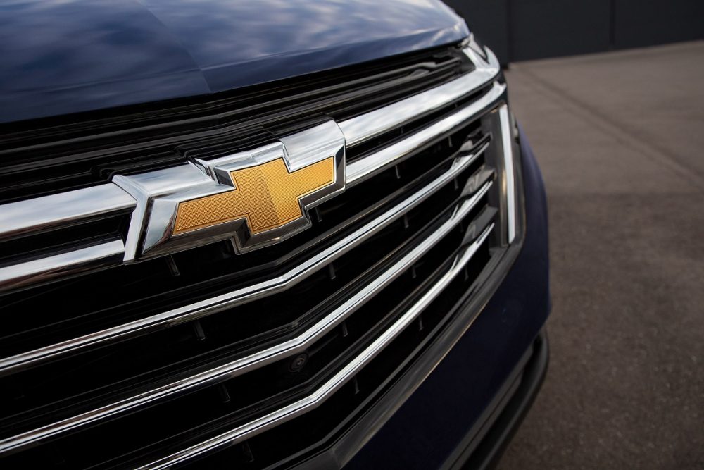 Close up image of the Chevrolet badge on the grille of a large Chevy SUV