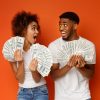 Two young people holding cash money