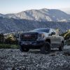 Front side view of 2023 GMC Sierra 1500 AT4X AEV Edition with mountain in background