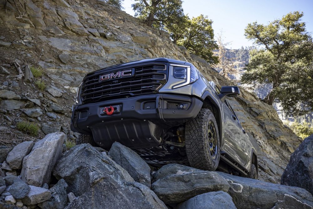 A view of the 2023 GMC Sierra 1500 AT4X AEV Edition's front underside as it maneuvers over rocks