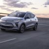 Front side view of Chevrolet Bolt EUV driving down road at sunset