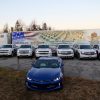 Decorated Chevy vehicles in front of a truck with an American flag on it