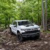 Front side overhead view of 2023 Chevrolet Silverado ZR2 Bison driving on rough terrain in the woods