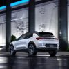 Rear side view of 2024 Chevrolet Equinox EV 3RS parked in front of building at night