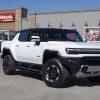 White GMC Hummer EV Pickup parked in front of Pilot travel center