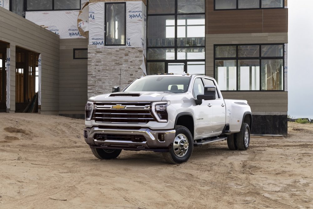 Front side view of white 2024 Chevrolet Silverado 3500HD at a worksite