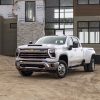 Front side view of white 2024 Chevrolet Silverado 3500HD at a worksite