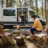 Couple at campsite with 2023 Ford Transit Trail