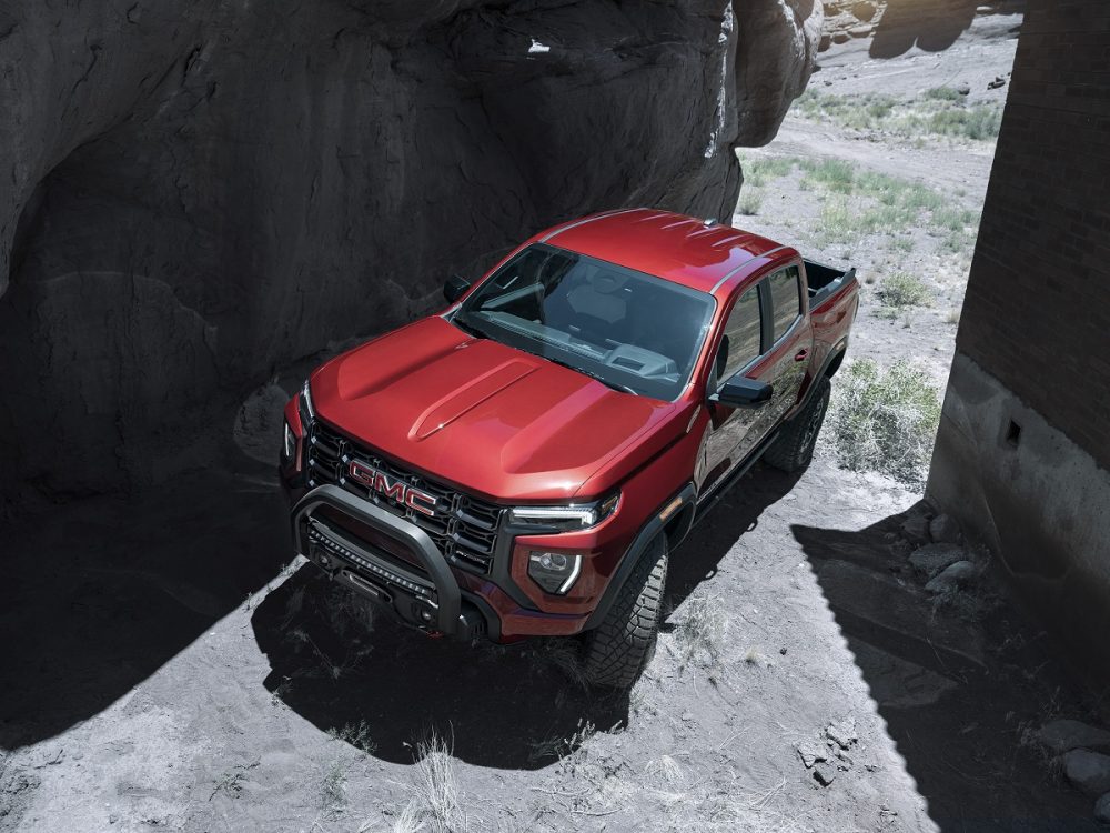 Overhead view of 2023 GMC Canyon AT4X driving uphill with cliffs on either side