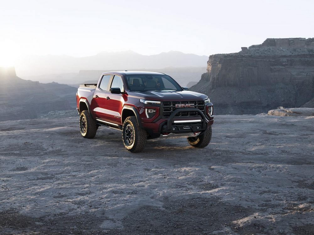 Front 3/4 view of 2023 GMC Canyon AT4X with Edition 1 package with a mountain view in the background