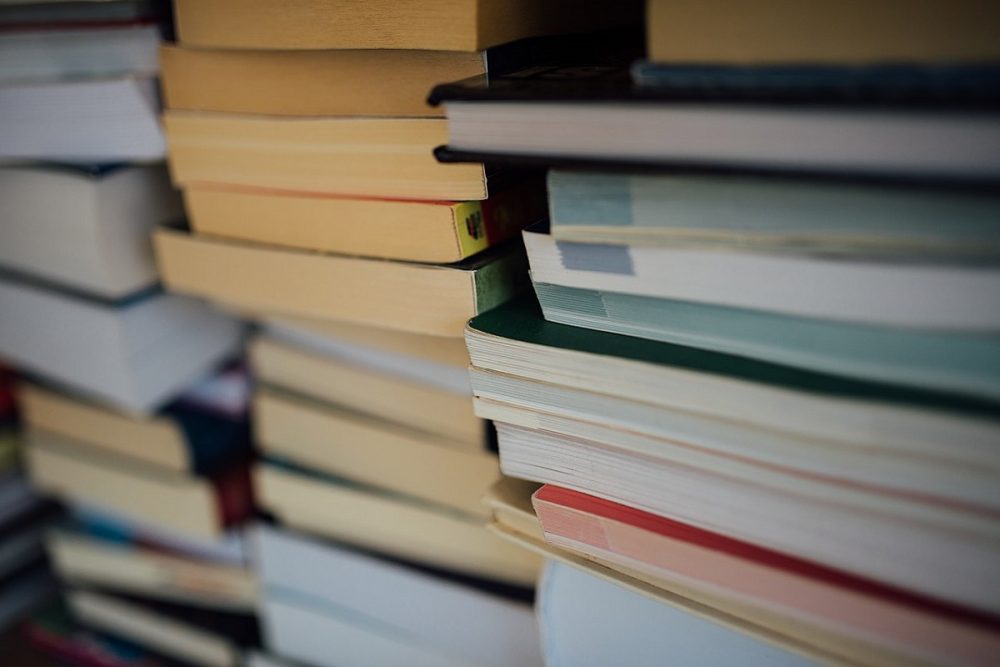 A close-up photo of books stacked in a pile