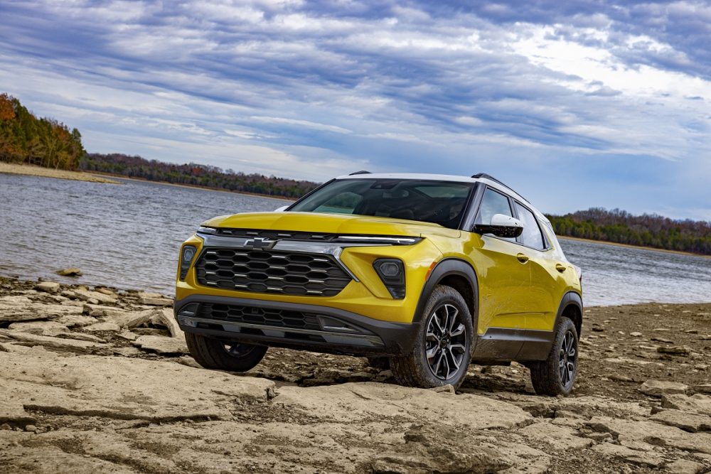 Front side view of yellow 2024 Chevrolet Trailblazer ACTIV in front of a lake