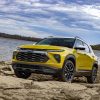 Front side view of yellow 2024 Chevrolet Trailblazer ACTIV in front of a lake