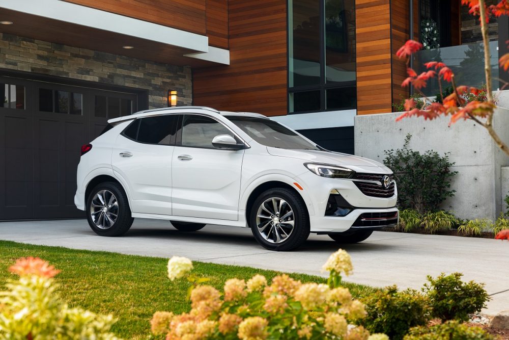 Front side view of white 2023 Buick Encore GX parked in a driveway