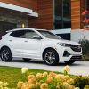 Front side view of white 2023 Buick Encore GX parked in a driveway