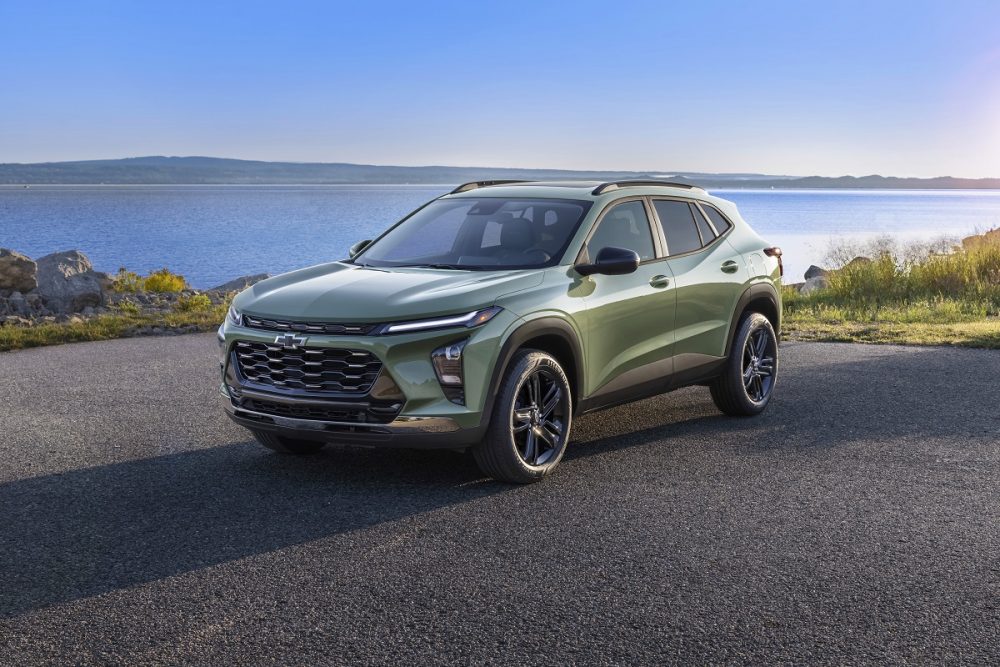 Front side view of green 2024 Chevrolet Trax ACTIV parked in front of water