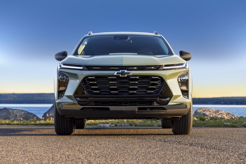 Front view of green 2024 Chevrolet Trax ACTIV parked in front of water