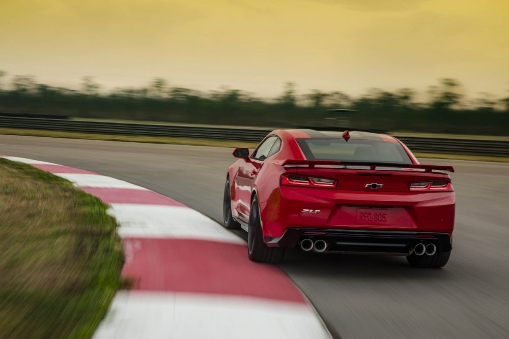 Rear view of red 2023 Chevrolet Camaro ZL1 cornering on a track