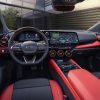 View of 2024 Chevrolet Blazer EV SS steering wheel, dashboard, display screens, and seats upholstered in black/Adrenaline Red