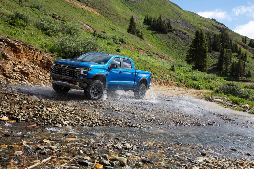 2024 Silverado ZR2 driving near a hillside.