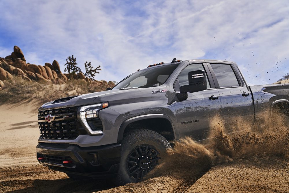 Side 3/4 view of 2024 Chevrolet Silverado HD ZR2 kicking up dust